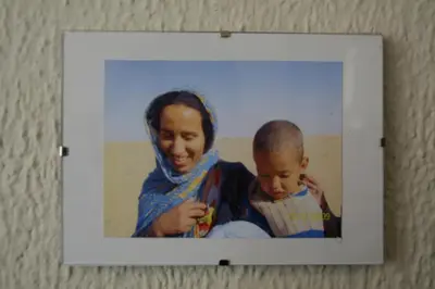 a woman holding a baby in a picture on a wall at Casas Lomas II in Arcos de la Frontera