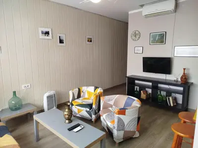 a living room with two chairs and a tv at Casas Lomas II in Arcos de la Frontera