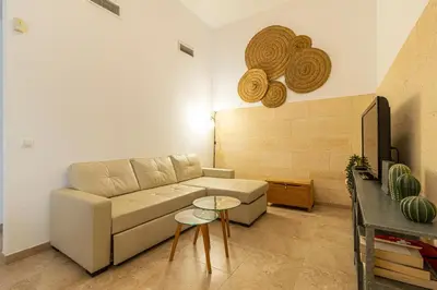 a living room with a couch and a table at Charming Apartment in Jerez de la Frontera