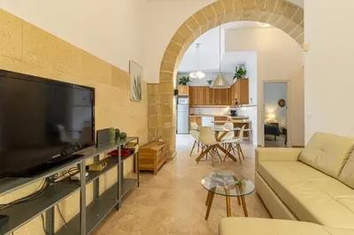 a living room with a couch and a tv at Charming Apartment in Jerez de la Frontera