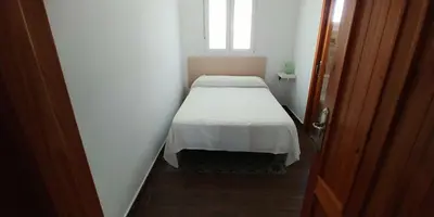 a small bed in a small room with a window at Casas Turísticas Bajamar in Sanlúcar de Barrameda