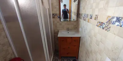 a small bathroom with a sink and a mirror at Casas Turísticas Bajamar in Sanlúcar de Barrameda
