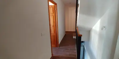 a hallway with a wooden door and a stairway at Casas Turísticas Bajamar in Sanlúcar de Barrameda
