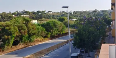 a street with a street light on the side of a road at Casas Turísticas Bajamar in Sanlúcar de Barrameda