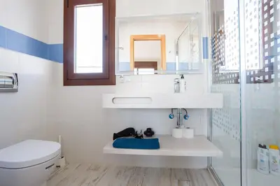 a bathroom with a sink and a toilet and a mirror at Atico FULL Balcony by Cadiz4Rentals in Cádiz