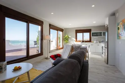 a living room with a couch and a table and a kitchen at Atico FULL Balcony by Cadiz4Rentals in Cádiz