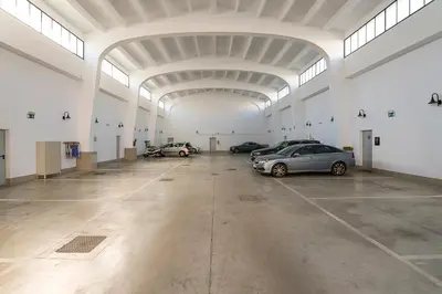a large garage with cars parked in it at Cream Loft Siente Jerez Parking Incluido in Jerez de la Frontera