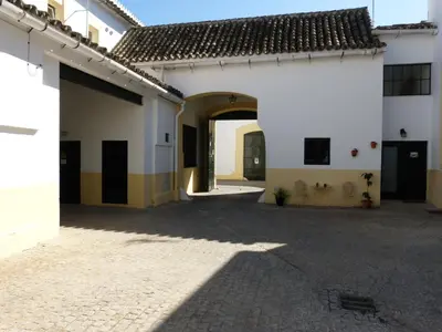 an empty courtyard of a building with an archway at Cream Loft Siente Jerez Parking Incluido in Jerez de la Frontera