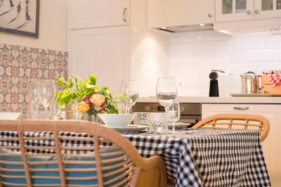 a kitchen with a table with wine glasses on it at Cream Loft Siente Jerez Parking Incluido in Jerez de la Frontera