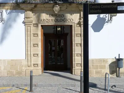 a sign in front of a building with a door at Cream Loft Siente Jerez Parking Incluido in Jerez de la Frontera