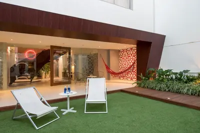 two chairs and a table in front of a building at La Alcoba del Agua Hotel Boutique in Sanlúcar de Barrameda