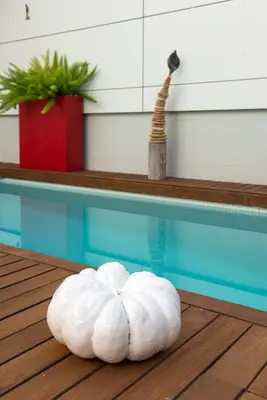 a white pillow sitting next to a swimming pool at La Alcoba del Agua Hotel Boutique in Sanlúcar de Barrameda
