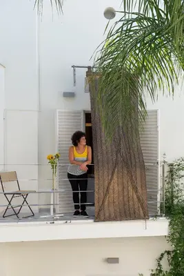a woman standing in a doorway of a building at La Alcoba del Agua Hotel Boutique in Sanlúcar de Barrameda