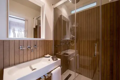a bathroom with a tub and a shower and a sink at La Alcoba del Agua Hotel Boutique in Sanlúcar de Barrameda