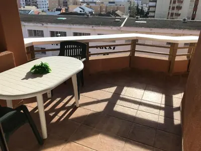 a white table and chair on a balcony with a view at Infantes 8-4-30 in Sanlúcar de Barrameda