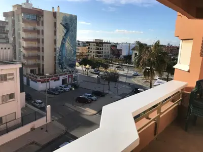 a view of a city from the balcony of a building at Infantes 8-4-30 in Sanlúcar de Barrameda