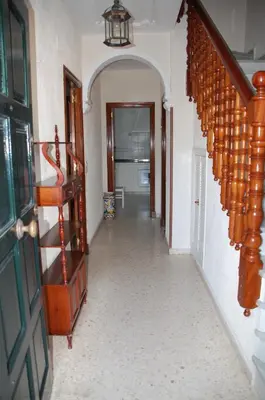 a hallway with a spiral staircase in a home at Casa Rosalia in Sanlúcar de Barrameda