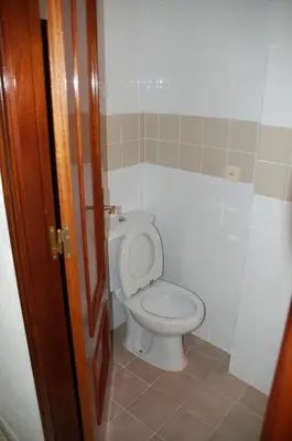 a bathroom with a toilet with the lid up at Casa Rosalia in Sanlúcar de Barrameda