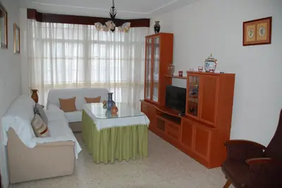 a living room with a couch and a tv at Casa Rosalia in Sanlúcar de Barrameda