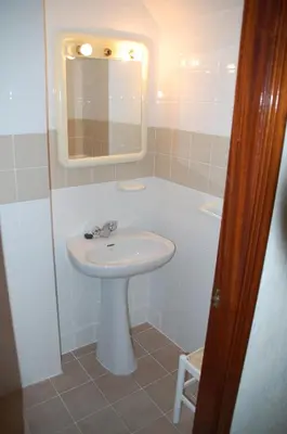 a bathroom with a white sink and a mirror at Casa Rosalia in Sanlúcar de Barrameda