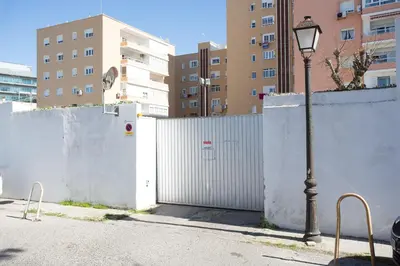 a street light next to a white fence at OCEANO Family Home free parking by Cadiz4Rentals in Cádiz
