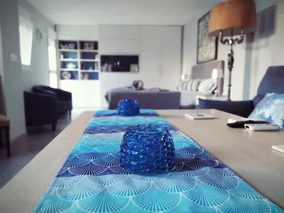 a table with a blue table cloth on top of it at Hostal Casa Nautilus in Cádiz