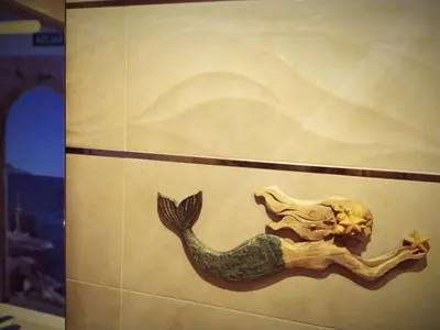 a painting of a mermaid on a wall at Hostal Casa Nautilus in Cádiz