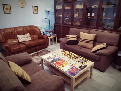 a living room with two couches and a coffee table at Hostal Casa Nautilus in Cádiz