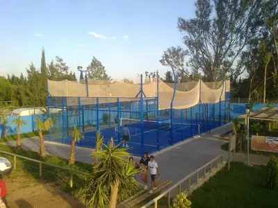two people walking in front of a play structure at Glamping -Bungalows El Faro in Conil de la Frontera