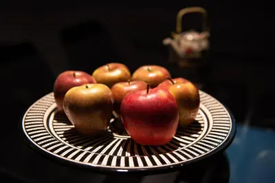 a pile of apples on a plate on a table at La Casa del Consul in Cádiz
