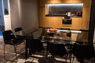 a kitchen with a table with a bowl of fruit on it at La Casa del Consul in Cádiz