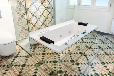 a bathroom with a white tub and a toilet at La Casa del Consul in Cádiz