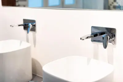 a bathroom with two faucets and a sink at La Casa del Consul in Cádiz
