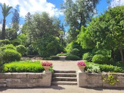 a garden with stairs and flowers in a park at Casa Viña de Alcántara in Jerez de la Frontera