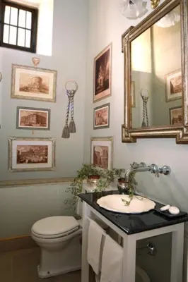 a bathroom with a toilet and a mirror and a sink at Casa Viña de Alcántara in Jerez de la Frontera