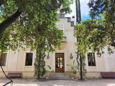 a building with trees in front of it at Casa Viña de Alcántara in Jerez de la Frontera