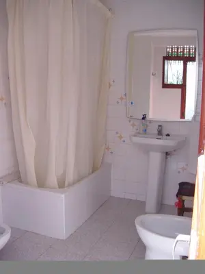 a bathroom with a shower curtain and a sink at Pensión San Andrés I in Jerez de la Frontera