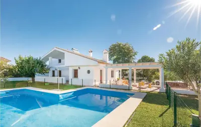 a villa with a swimming pool in front of a house at Awesome Home In Arcos De La Frontera in Arcos de la Frontera