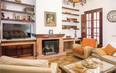 a living room with a fireplace and a tv at Awesome Home In Arcos De La Frontera in Arcos de la Frontera