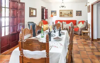 a dining room with a table and a couch at Awesome Home In Arcos De La Frontera in Arcos de la Frontera