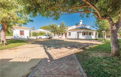 a house with a car parked in the driveway at Awesome Home In Arcos De La Frontera in Arcos de la Frontera