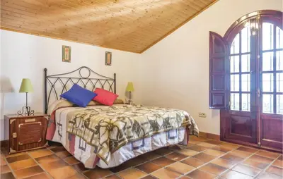 a bedroom with a bed and a wooden ceiling at Awesome Home In Arcos De La Frontera in Arcos de la Frontera