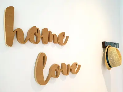a wooden sign that reads living eco hanging on a wall at Sherryflat Fate in Jerez de la Frontera