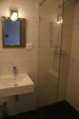 a bathroom with a sink and a glass shower at Bed & Breakfast Casa El Sueño in Arcos de la Frontera