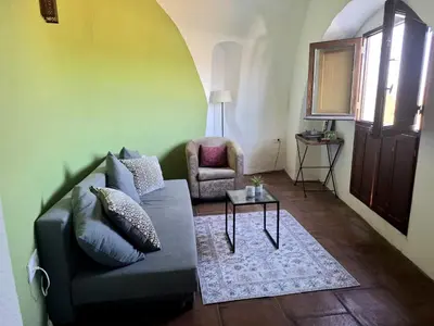 a living room with a couch and a chair at Bed & Breakfast Casa El Sueño in Arcos de la Frontera