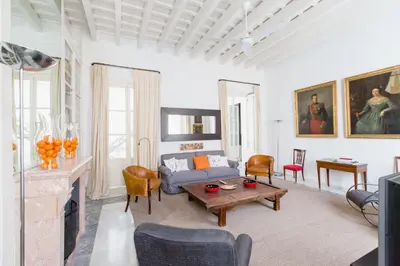 a living room with a couch and a table at Apartamentos La Botanica, Cadiz in Cádiz