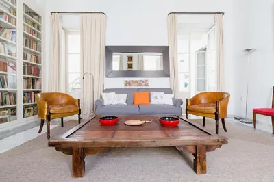 a living room with a couch and two chairs at Apartamentos La Botanica, Cadiz in Cádiz