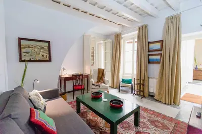 a living room with a couch and a table at Apartamentos La Botanica, Cadiz in Cádiz