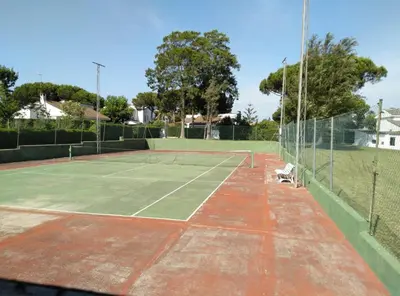 a tennis court with a cat sitting on top of it at Chalet en Roche in Conil de la Frontera