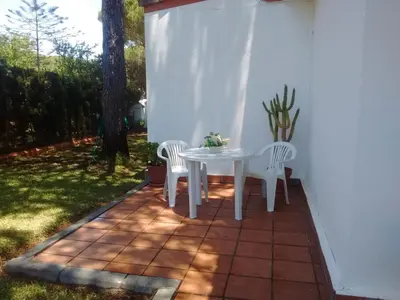 a white table and two chairs on a patio at Chalet en Roche in Conil de la Frontera